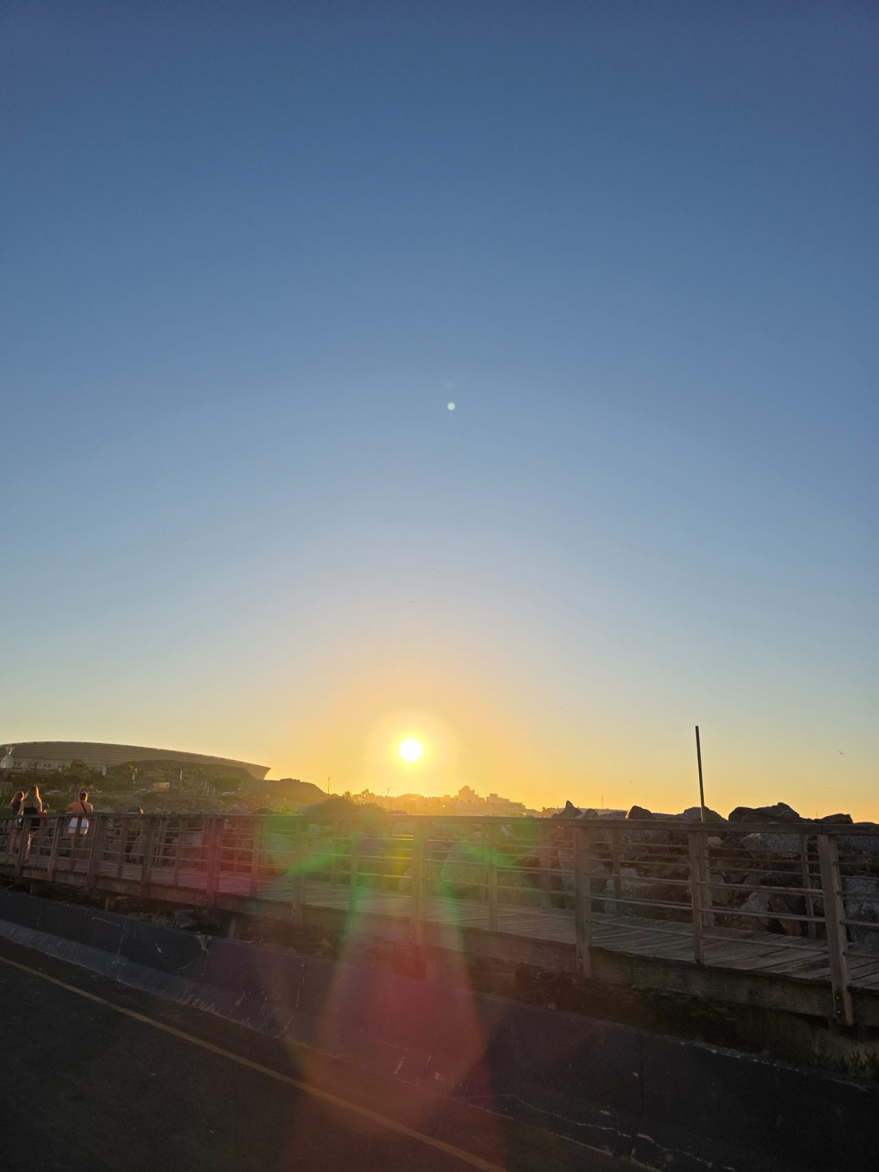 Cape Town Stadium and Sea Point promenade at golden hour